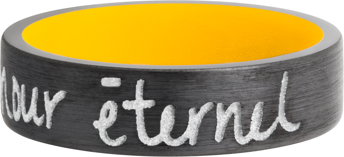 zirconium 7mm flat band with slightly rounded edges and a laser-carved handwritten message with a yellow cerakote sleeve