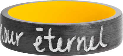 Zirconium 7mm flat band with slightly rounded edges and a laser-carved handwritten message with a yellow Cerakote sleeve